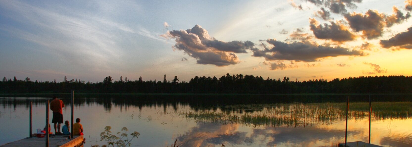 A Dad And Kids On The End Of A Dock During Sunset 2024 05 27 00 54 30 Utc